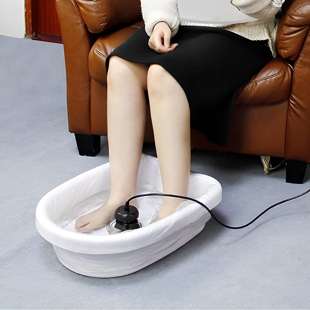 Closeup of feet soaking in ionic detox foot bath