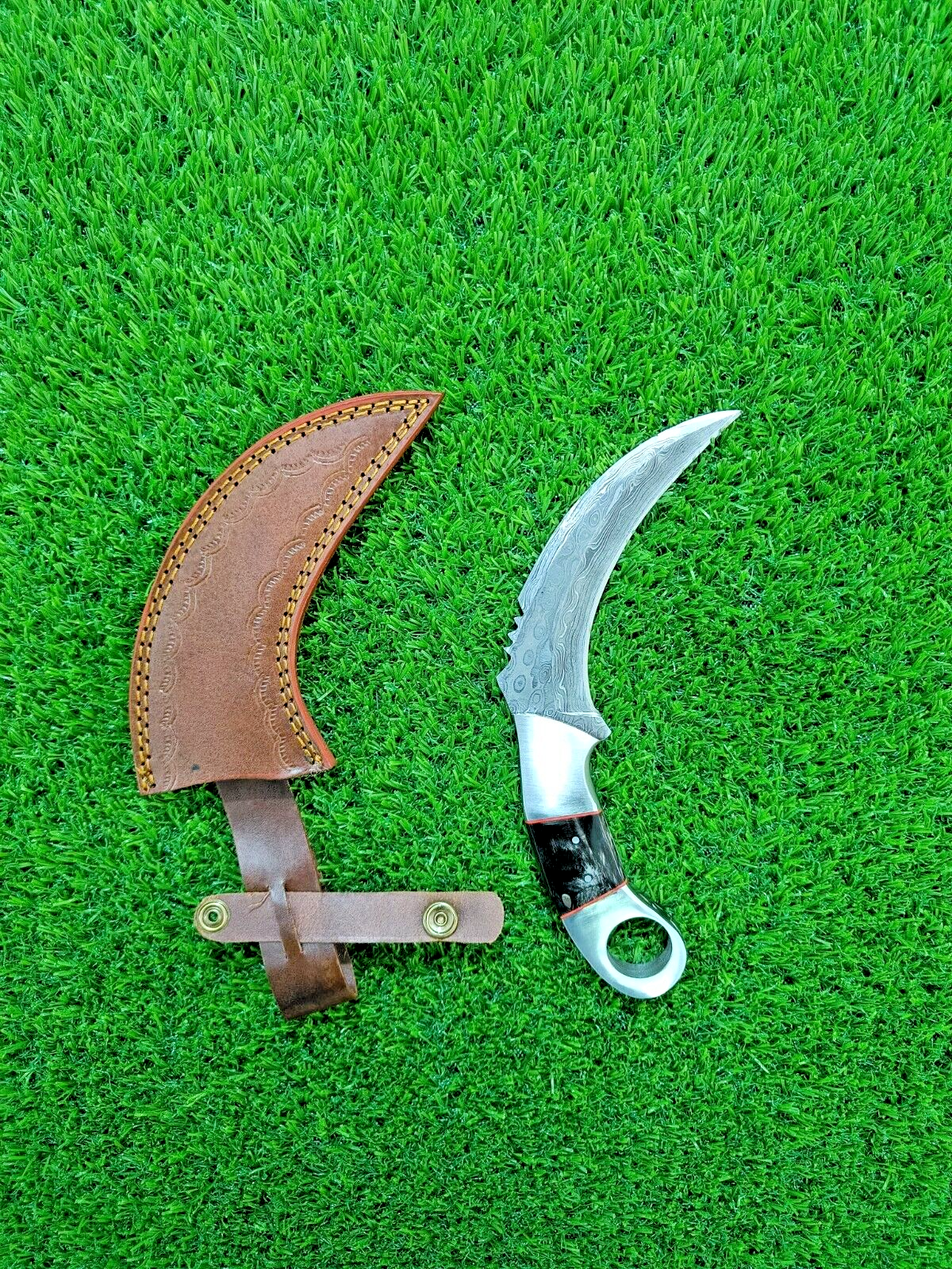 Damascus karambit knife with rain drop pattern and steel bolster, bull horn